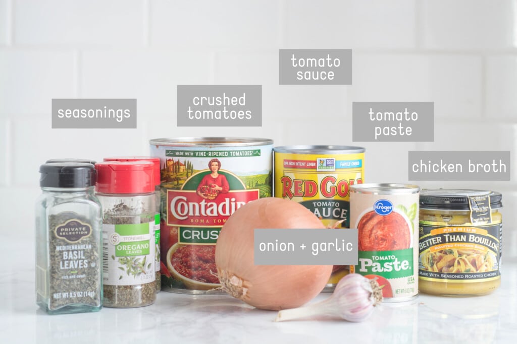 Ingredients for Spaghetti Sauce with Meat sit on a white counter.